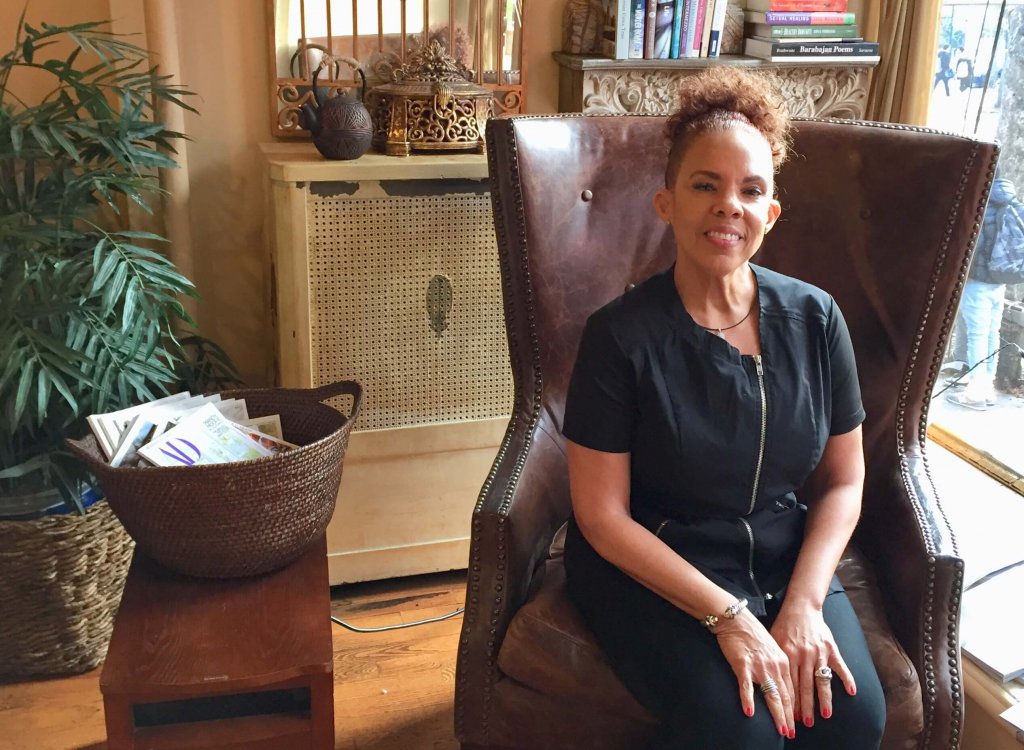 Owner of Cynergy Spa Marsha-Ann Boyea sitting in chair in her spa