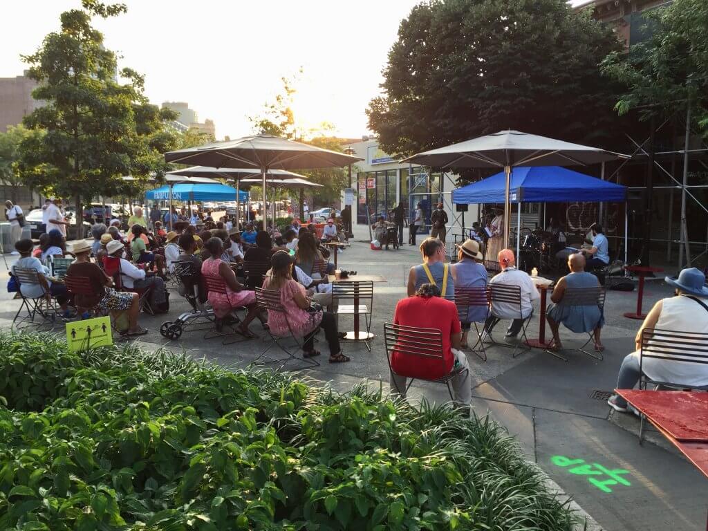 Daytime outdoor jazz concert at plaza with audience