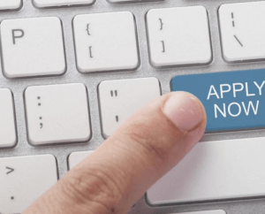 Finger on a computer keyboard, pressing "Apply Now"
