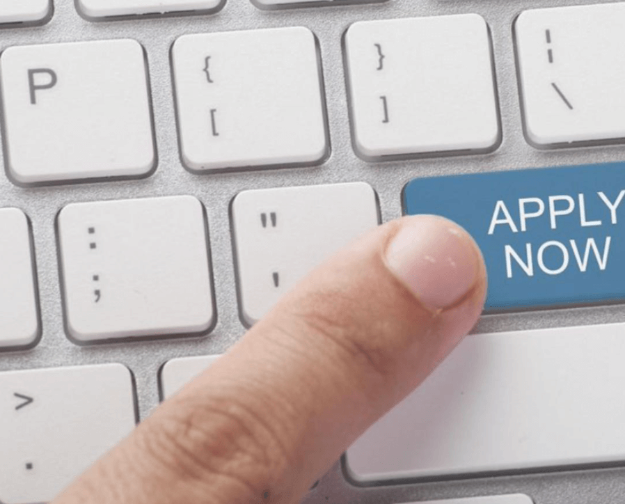 Finger on a computer keyboard, pressing "Apply Now"