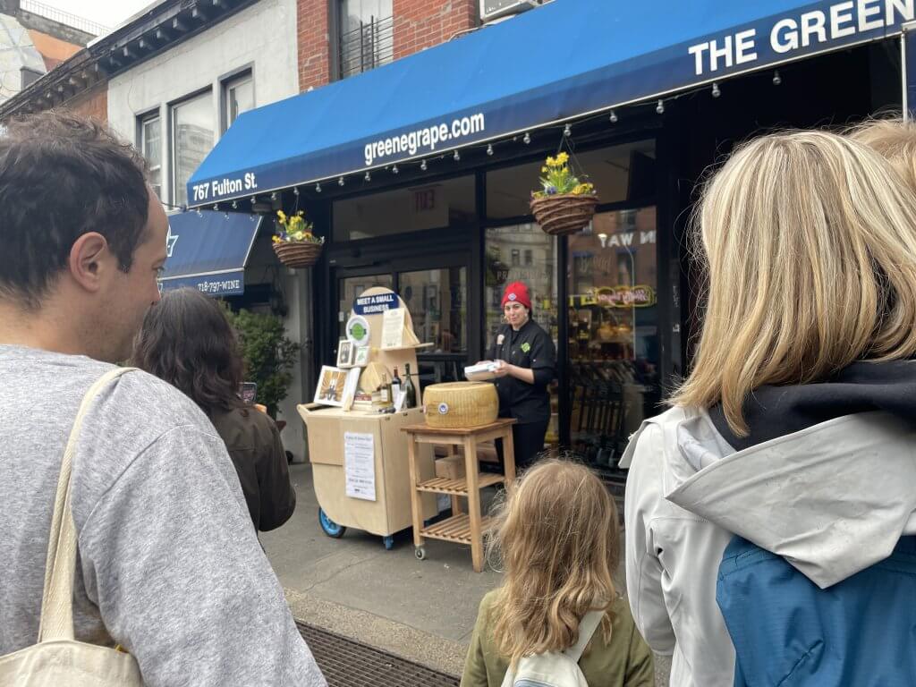 Crowd at Greene Grape watching cheese monger demonstration