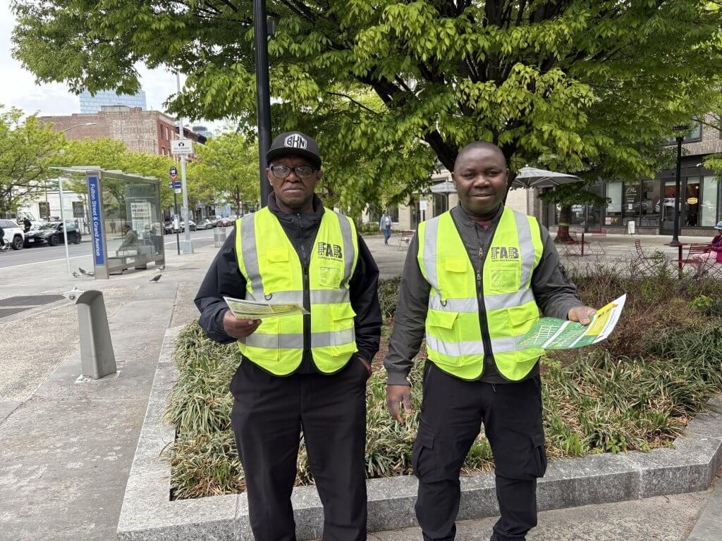 Two uniformed safety ambassadors standing in the plaza