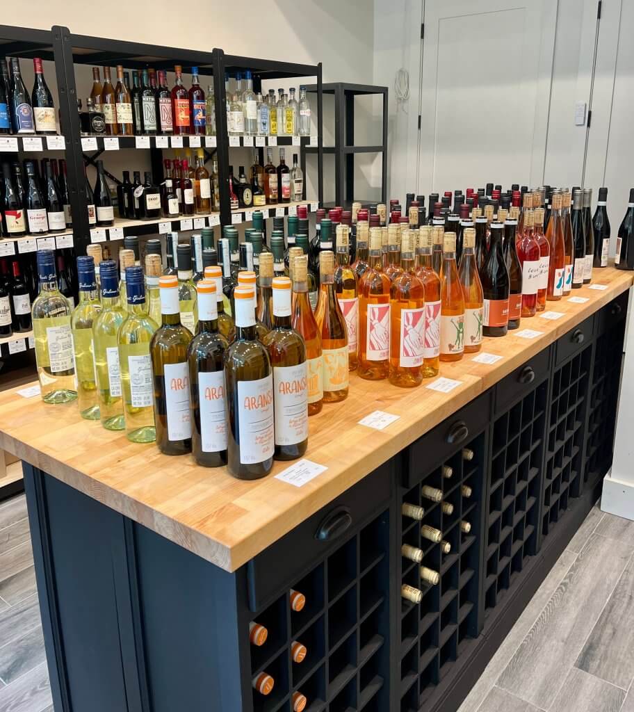 Shelves and table of wines at Olivino Wine store